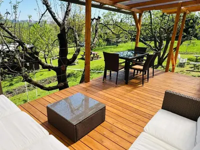 a wooden deck with a table and chairs on it at Glamping Prokop in Prague