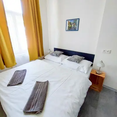 a bedroom with two beds with towels on them at Room close to the centre H4 in Prague