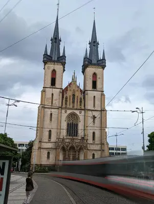 an old church with two towers on a street at Letní pokoj na Pražské Letné H5 in Prague