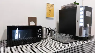 a counter with a microwave and a toaster oven on it at Letní pokoj na Pražské Letné H5 in Prague