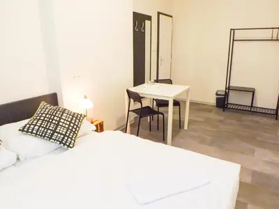 a bedroom with a table and a bed and a table at Letní pokoj na Pražské Letné H5 in Prague