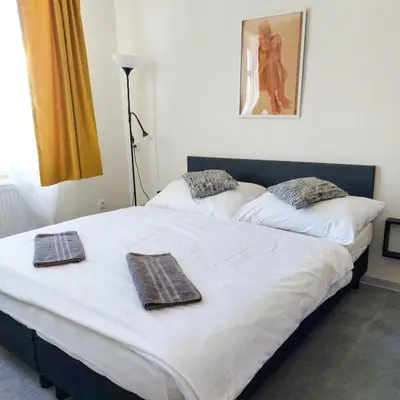 two beds in a bedroom with towels on them at Room for 3 number1 Prague 7 in Prague
