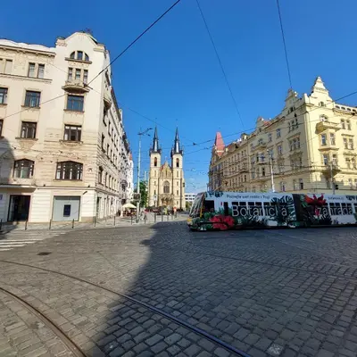a bus is parked in a city street with buildings at Room for 3 number1 Prague 7 in Prague