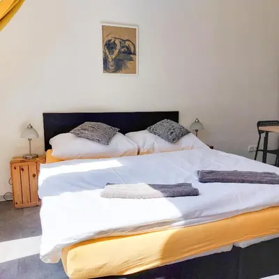 two beds sitting next to each other in a room at Beautiful attic room R3 in Prague