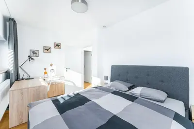 a bedroom with a black and white checkered bed at Dvouložnicový mezonetový apartmán se dvěma koupelnami v rodinné vile in Prague