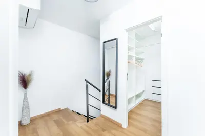 a hallway with a mirror and a vase at Dvouložnicový mezonetový apartmán se dvěma koupelnami v rodinné vile in Prague