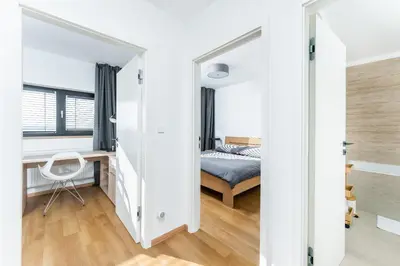 a bedroom with a bed and a desk in a room at Dvouložnicový mezonetový apartmán se dvěma koupelnami v rodinné vile in Prague