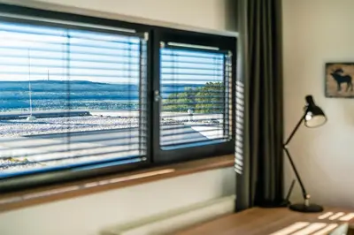 a room with a window with a view of a beach at Dvouložnicový mezonetový apartmán se dvěma koupelnami v rodinné vile in Prague