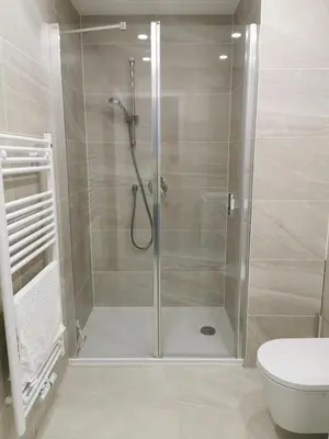 a shower with a glass door in a bathroom at free private Parking, central location, Nuslesky Pivovar sunset balcony home, in Prague