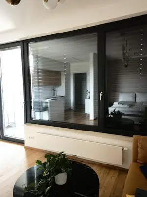 a large window in a room with a bed and a table at free private Parking, central location, Nuslesky Pivovar sunset balcony home, in Prague