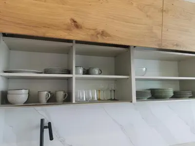a cabinet with plates and cups and dishes in it at free private Parking, central location, Nuslesky Pivovar sunset balcony home, in Prague