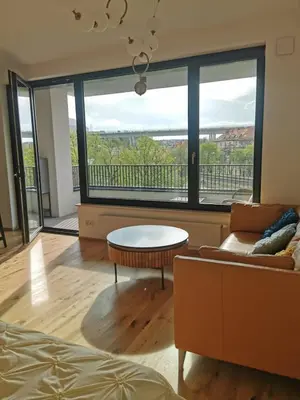 a living room with a couch and a table at free private Parking, central location, Nuslesky Pivovar sunset balcony home, in Prague