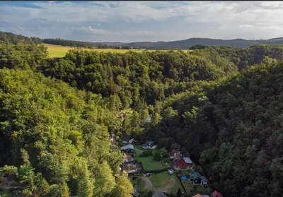 an aerial view of a house in the middle of a forest at fairy tale cottage on water stream, 30 minutes from South Prague in Davle