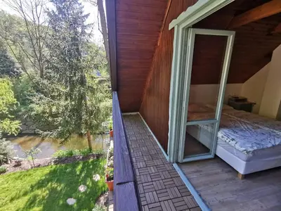 a room with a window and a bed on a porch at fairy tale cottage on water stream, 30 minutes from South Prague in Davle