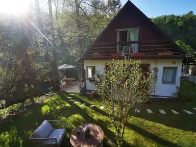 a small house in the middle of a yard at fairy tale cottage on water stream, 30 minutes from South Prague in Davle