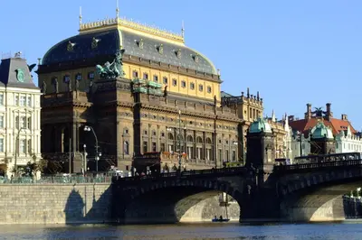 a bridge over a river in front of a building at Angel room with large terrace R6 in Prague