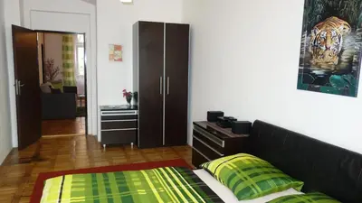 a bedroom with a bed and a dresser and a closet at Apartments Rokytka - Praha in Prague