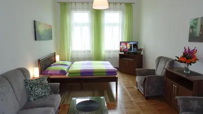 a living room with a couch and a table at Apartments Rokytka - Praha in Prague