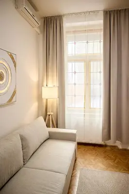 a living room with a couch and a window at Alma Apartments in Prague