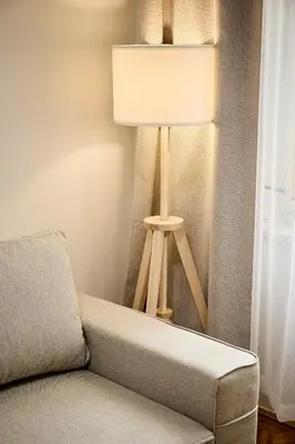 a lamp sitting next to a couch next to a window at Alma Apartments in Prague