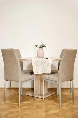 a table with two chairs and a vase on it at Alma Apartments in Prague