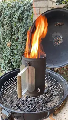 a grill with a pot with fire in it at Garden house on the Vltava riverbank 15 min to Prague in Kralupy nad Vltavou