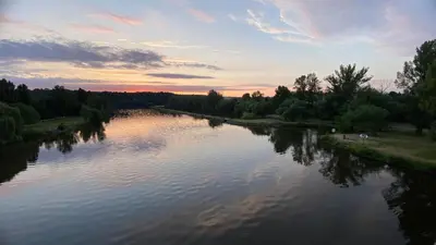 a view of a river at sunset at Garden house on the Vltava riverbank 15 min to Prague in Kralupy nad Vltavou