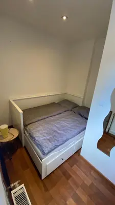 a small bedroom with a bed in a room at Garden house on the Vltava riverbank 15 min to Prague in Kralupy nad Vltavou