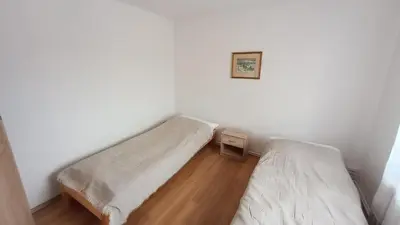 a room with two beds and a picture on the wall at Apartmán Mělník 330 in Mělník