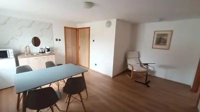 a kitchen with a table and chairs in a room at Apartmán Mělník 330 in Mělník