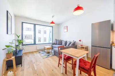a living room with a couch and a table at Peaceful and cosy newly built studio with parking in Prague