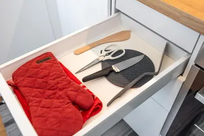 a drawer with a pair of scissors and a cloth at Peaceful and cosy newly built studio with parking in Prague