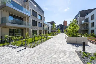 an empty sidewalk in front of a building at Peaceful and cosy newly built studio with parking in Prague