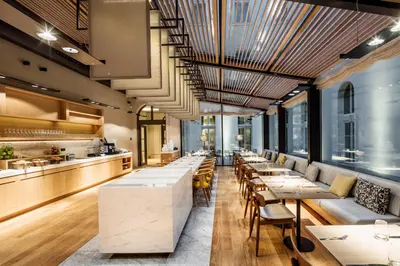a restaurant with tables and chairs and a bar at BoHo Prague Hotel - Small Luxury Hotels in Prague