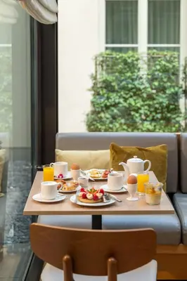 a table with breakfast foods and drinks on it at BoHo Prague Hotel - Small Luxury Hotels in Prague