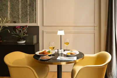a dining room with a table with food and wine glasses at BoHo Prague Hotel - Small Luxury Hotels in Prague