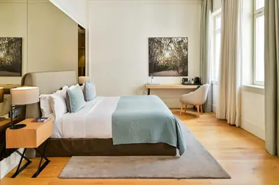 a bedroom with a large bed and a desk at BoHo Prague Hotel - Small Luxury Hotels in Prague