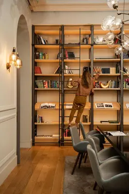 a child jumping on a shelf in a library at BoHo Prague Hotel - Small Luxury Hotels in Prague