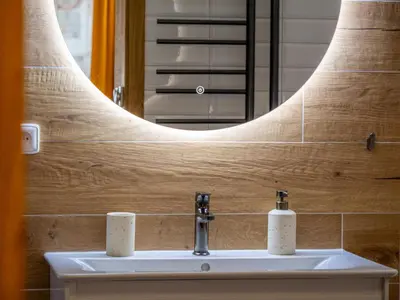 a bathroom with a sink and a mirror at Apartmán Mick Jagger in Nymburk