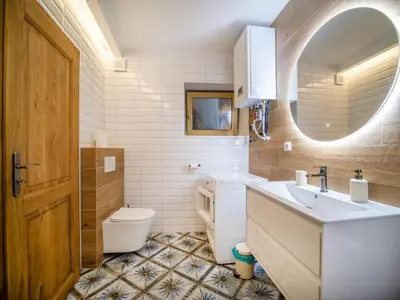a bathroom with a sink and a toilet and a mirror at Apartmán Mick Jagger in Nymburk