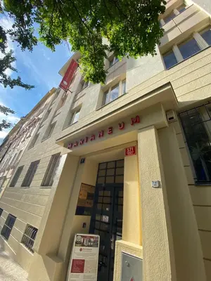 a building with a sign in front of it at Hotel Marianeum in Prague
