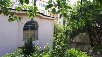 a building with a large window in a garden at Hotel Marianeum in Prague