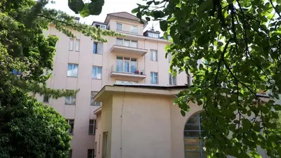 a pink building with a balcony on top of it at Hotel Marianeum in Prague