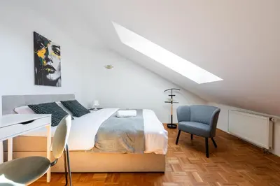 a bedroom with a bed and a desk and a chair at Apartment with terrace in Prague Center in Prague