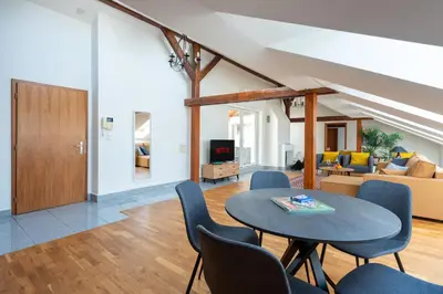 a living room with a table and chairs and a couch at Apartment with terrace in Prague Center in Prague