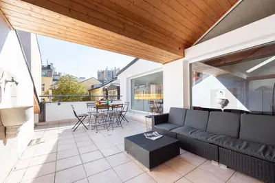 a living room with a couch and a table on a balcony at Apartment with terrace in Prague Center in Prague