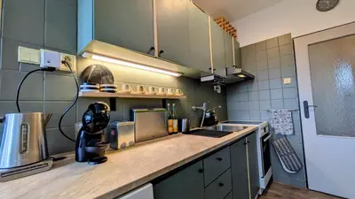 a kitchen with a sink and a counter top at Stylish Prague 6 Apartment with balcony in Prague