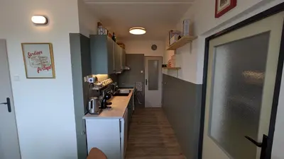 a small kitchen with a counter and a counter top at Stylish Prague 6 Apartment with balcony in Prague