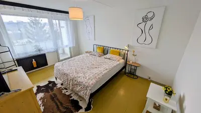 a bedroom with a bed and a window at Stylish Prague 6 Apartment with balcony in Prague