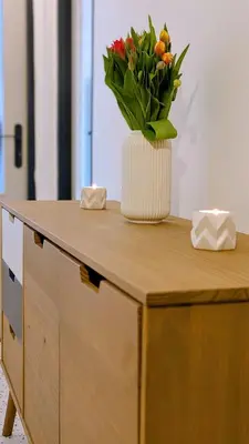 a vase of flowers sitting on top of a desk at Stylish Prague 6 Apartment with balcony in Prague